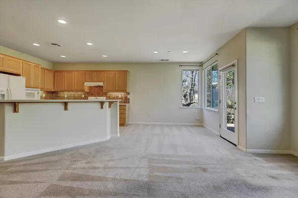 a kitchen with stainless steel appliances granite countertop a refrigerator and a stove top oven