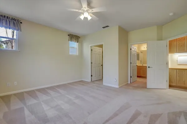 an empty room with fan and entrance