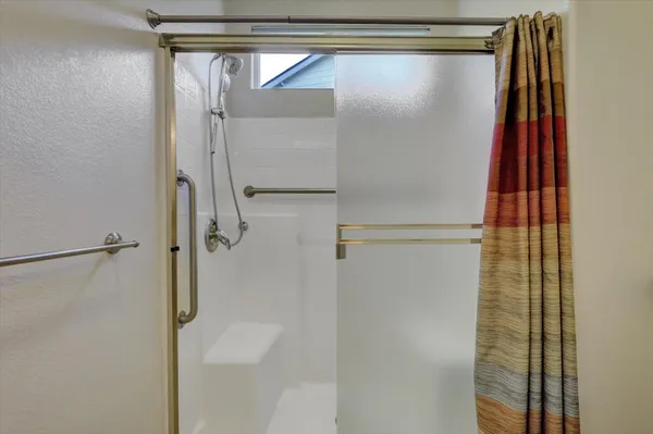 a bathroom with a glass shower door