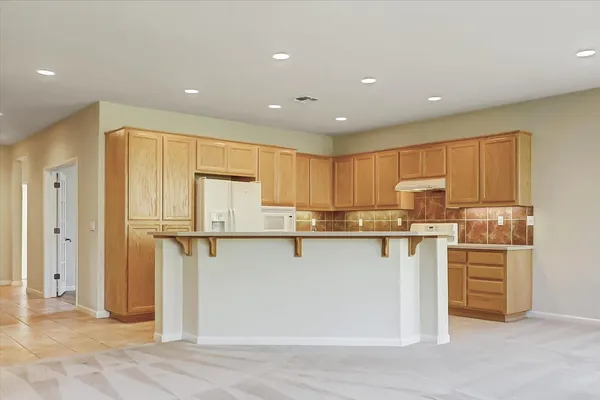 a kitchen with stainless steel appliances a refrigerator sink and cabinets