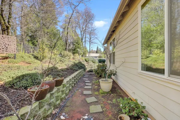 a pathway of a house with a yard