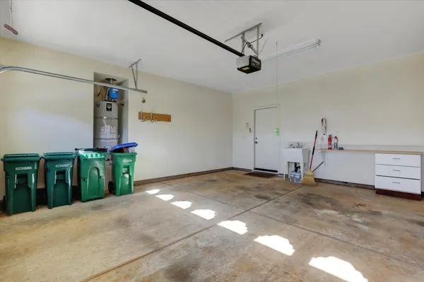 a backyard of a house with large trees and plants