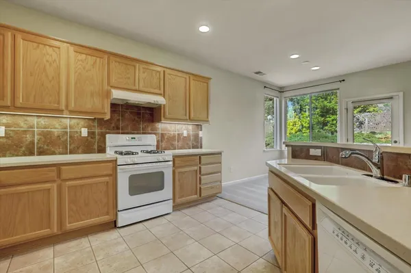 a kitchen with a sink stove and cabinets