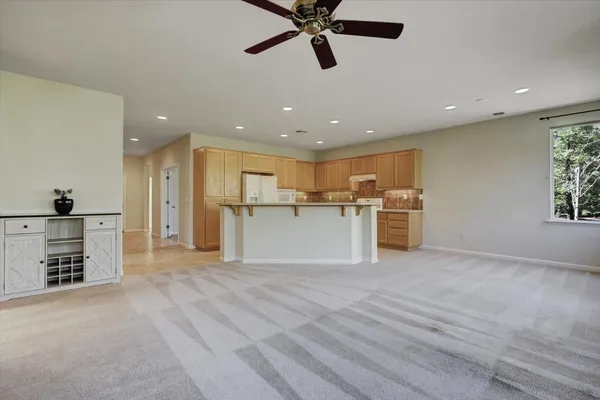 a view of a kitchen with a sink stainless steel appliances and cabinets