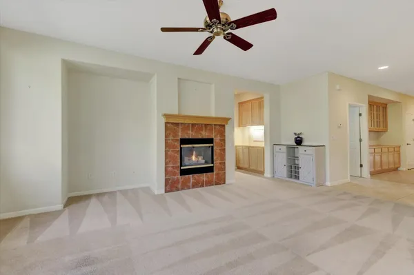 a view of empty room with a fireplace