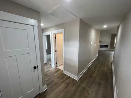 a view of a hallway with wooden floor