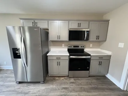 a kitchen with a refrigerator stove and microwave