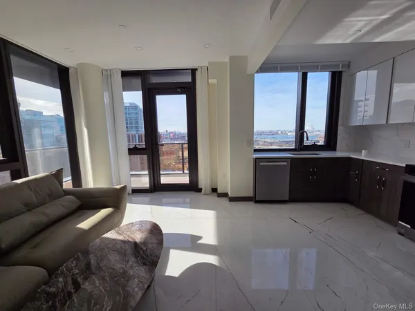 a living room with furniture and large windows