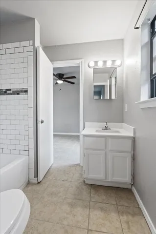 a bathroom with a double vanity sink toilet and shower