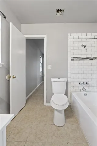 a white toilet sitting next to a bathroom sink