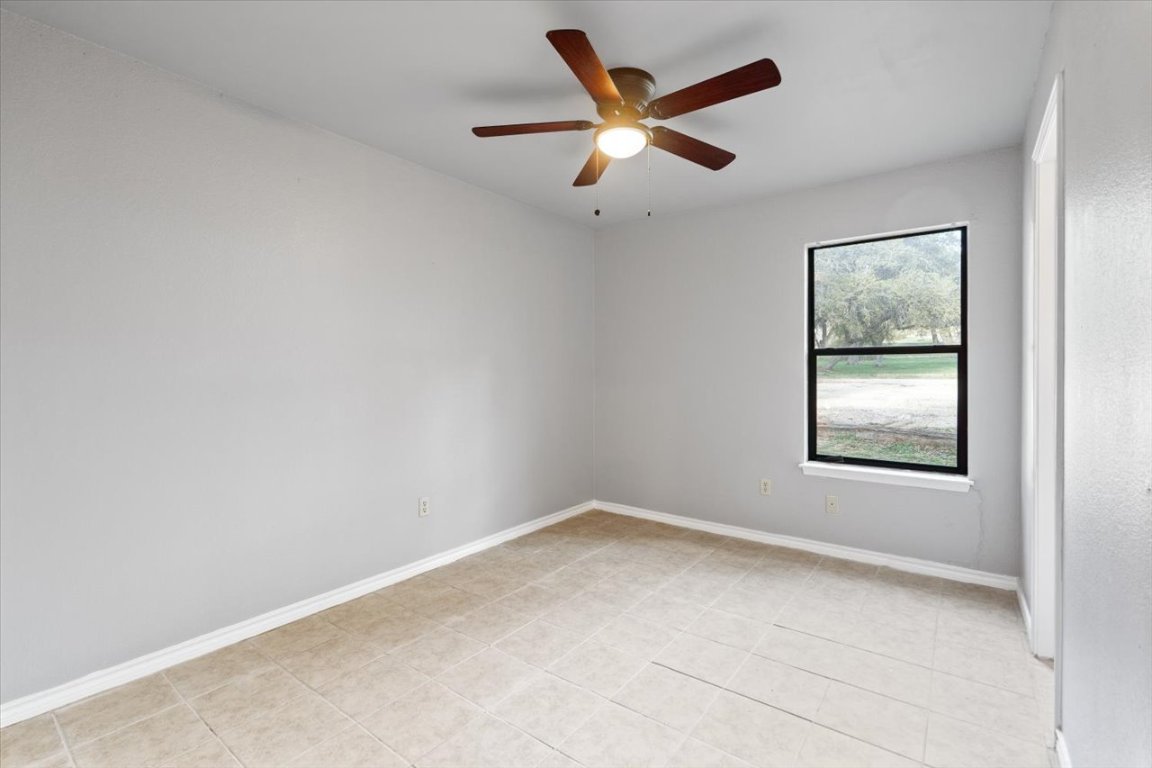 23393 Nameless Road, Unit 156 Leander, TX 78641 - Photo 19 of 21 an empty room with a window and a ceiling fan