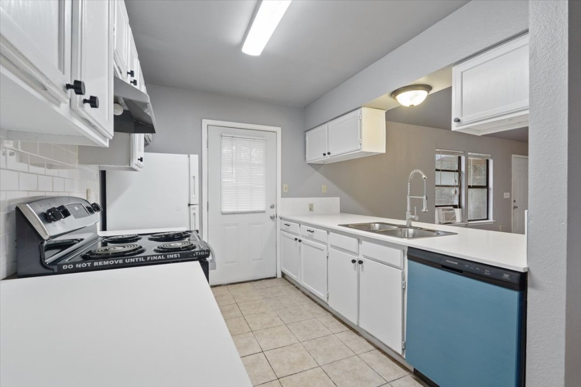 23393 Nameless Road, Unit 156 Leander, TX 78641 - Photo 7 of 21 a kitchen with sink cabinets and stove