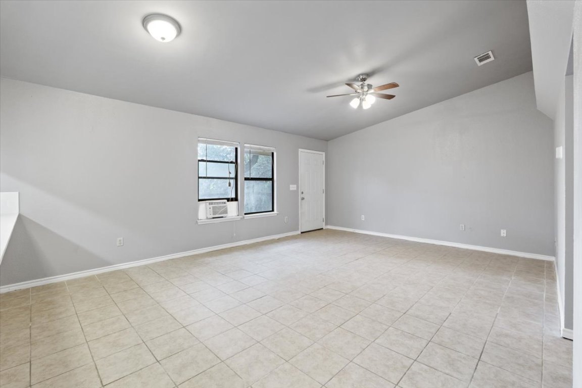 23393 Nameless Road, Unit 156 Leander, TX 78641 - Photo 10 of 21 an empty room with windows and ceiling fan