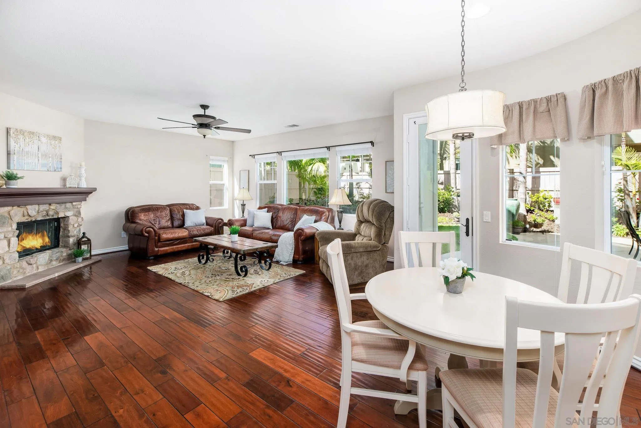650 Liquid Amber Way San Marcos, CA 92078 - Photo 20 of 48 a view of a dining room with furniture window and wooden floor