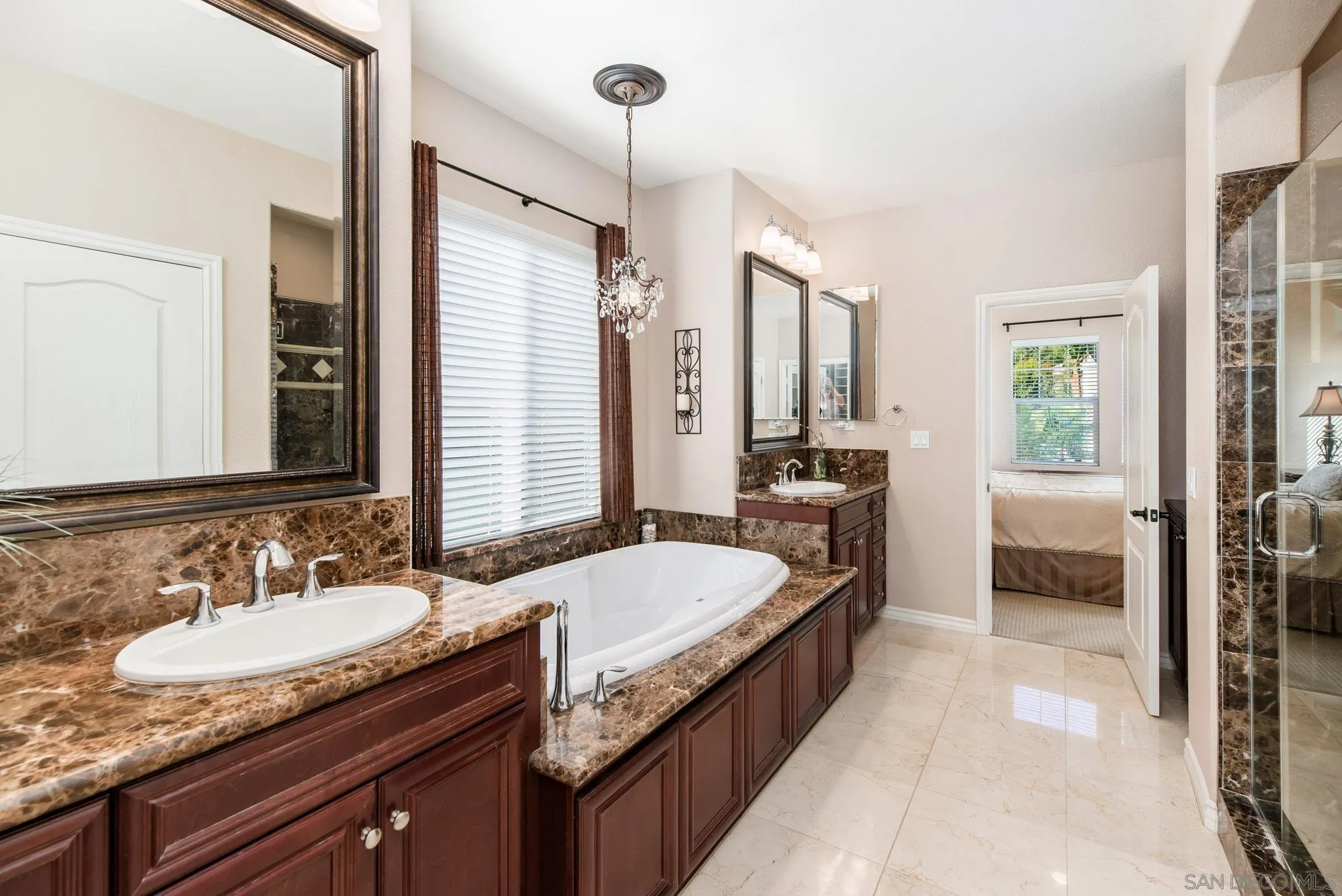 650 Liquid Amber Way San Marcos, CA 92078 - Photo 30 of 48 a en suite bathroom with a granite countertop double vanity sink a mirror and a shower