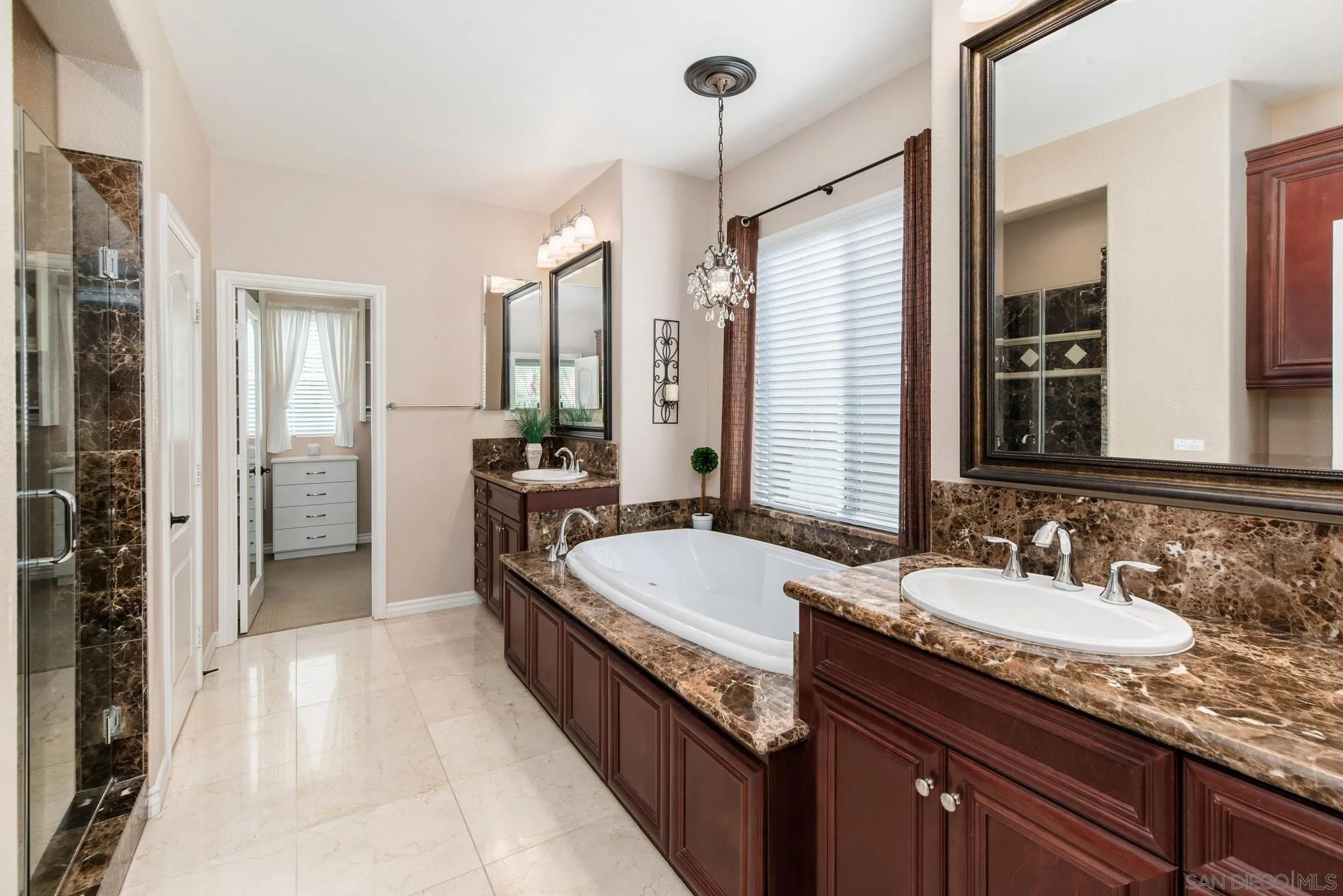 650 Liquid Amber Way San Marcos, CA 92078 - Photo 31 of 48 a bathroom with a granite countertop double vanity sink a mirror and a shower