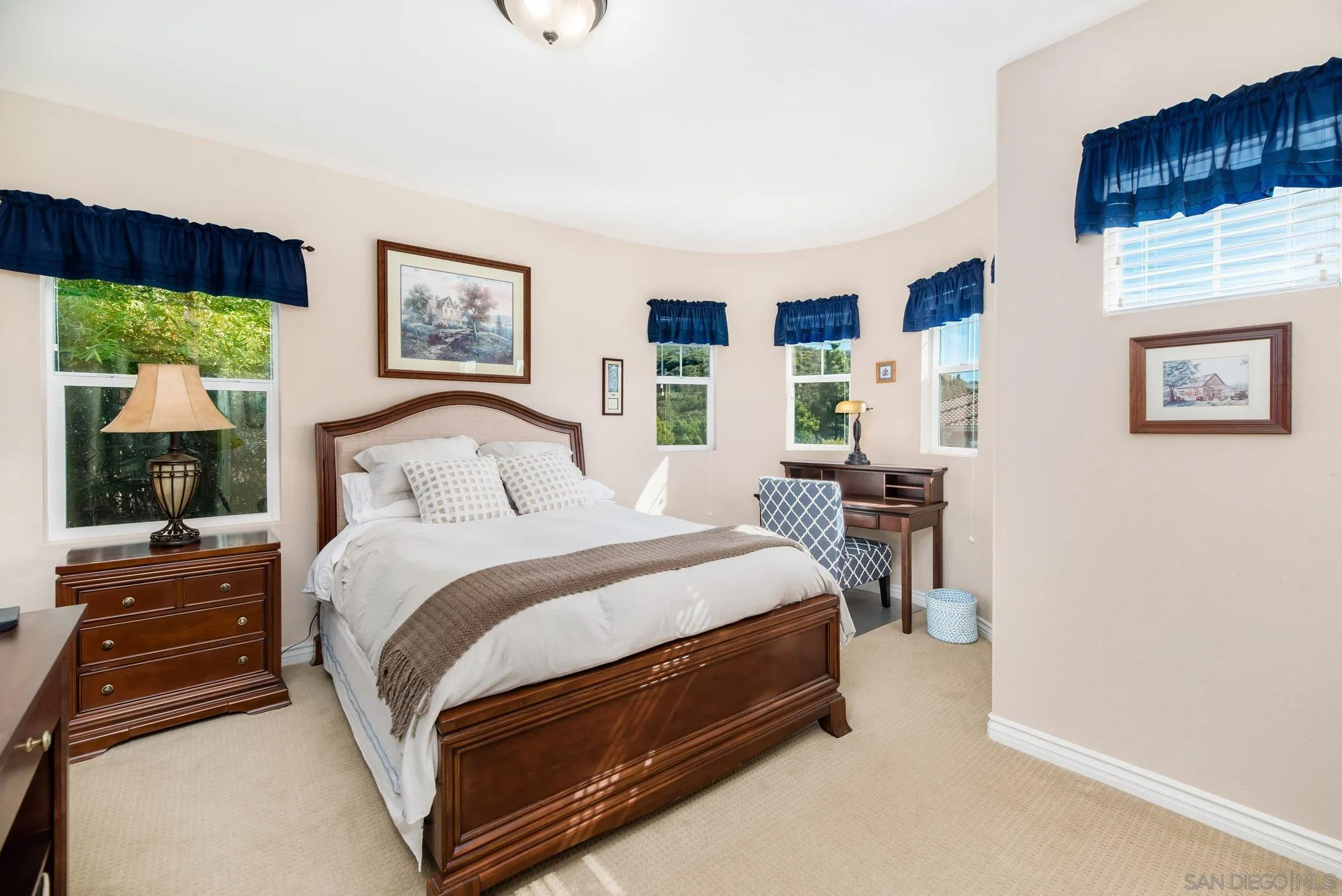 650 Liquid Amber Way San Marcos, CA 92078 - Photo 35 of 48 a bedroom with a bed and a flat tv screen on dresser