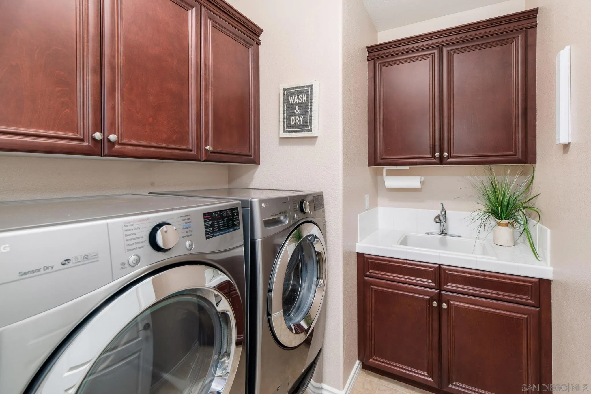 650 Liquid Amber Way San Marcos, CA 92078 - Photo 37 of 48 a utility room with sink dryer and washer