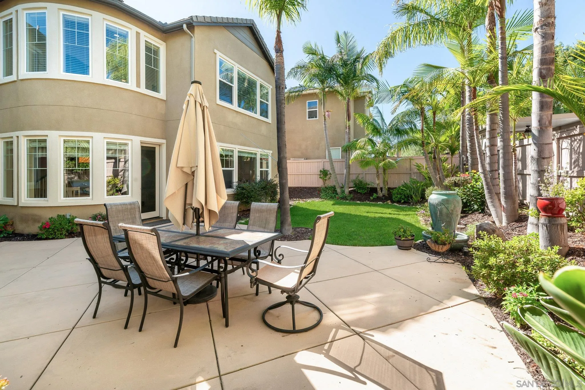 650 Liquid Amber Way San Marcos, CA 92078 - Photo 38 of 48 a view of a patio with table and chairs and potted plants