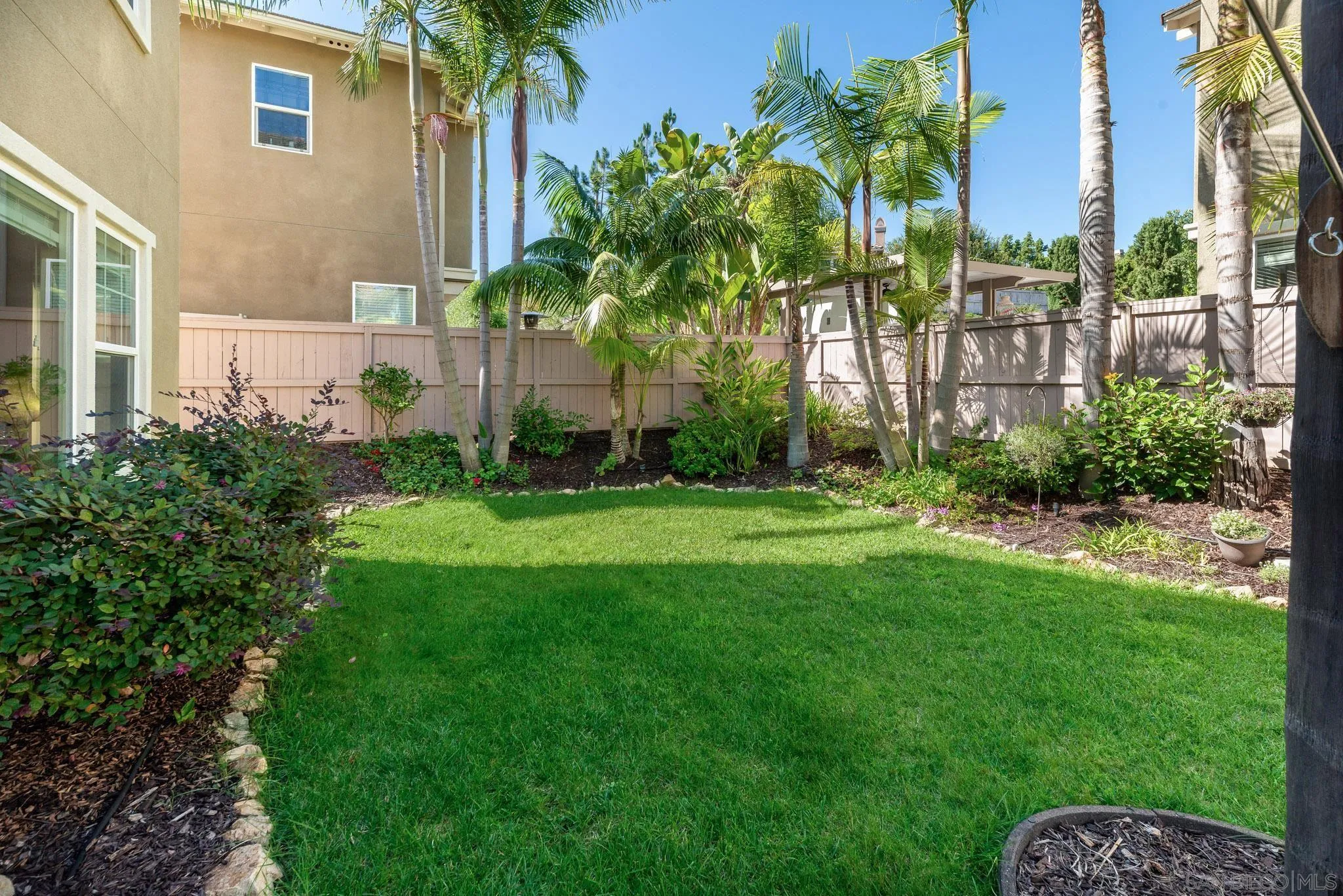 650 Liquid Amber Way San Marcos, CA 92078 - Photo 40 of 48 a front view of a house with a yard and potted plants