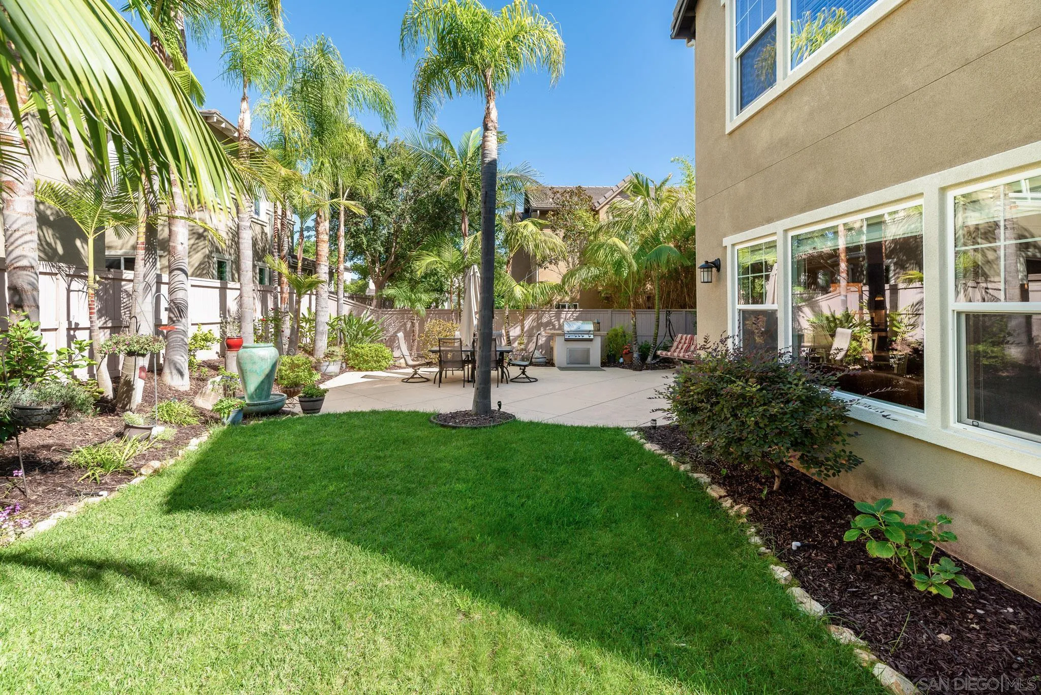 650 Liquid Amber Way San Marcos, CA 92078 - Photo 42 of 48 a view of a building with a garden