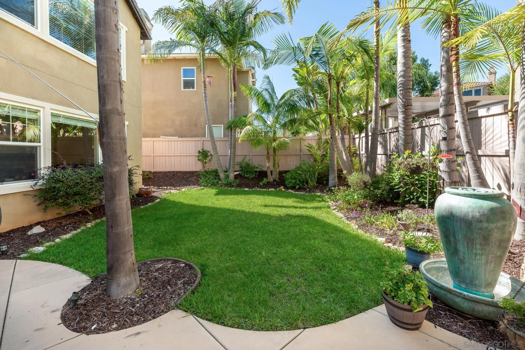 650 Liquid Amber Way San Marcos, CA 92078 - Photo 43 of 48 a view of a backyard with plants and a fountain
