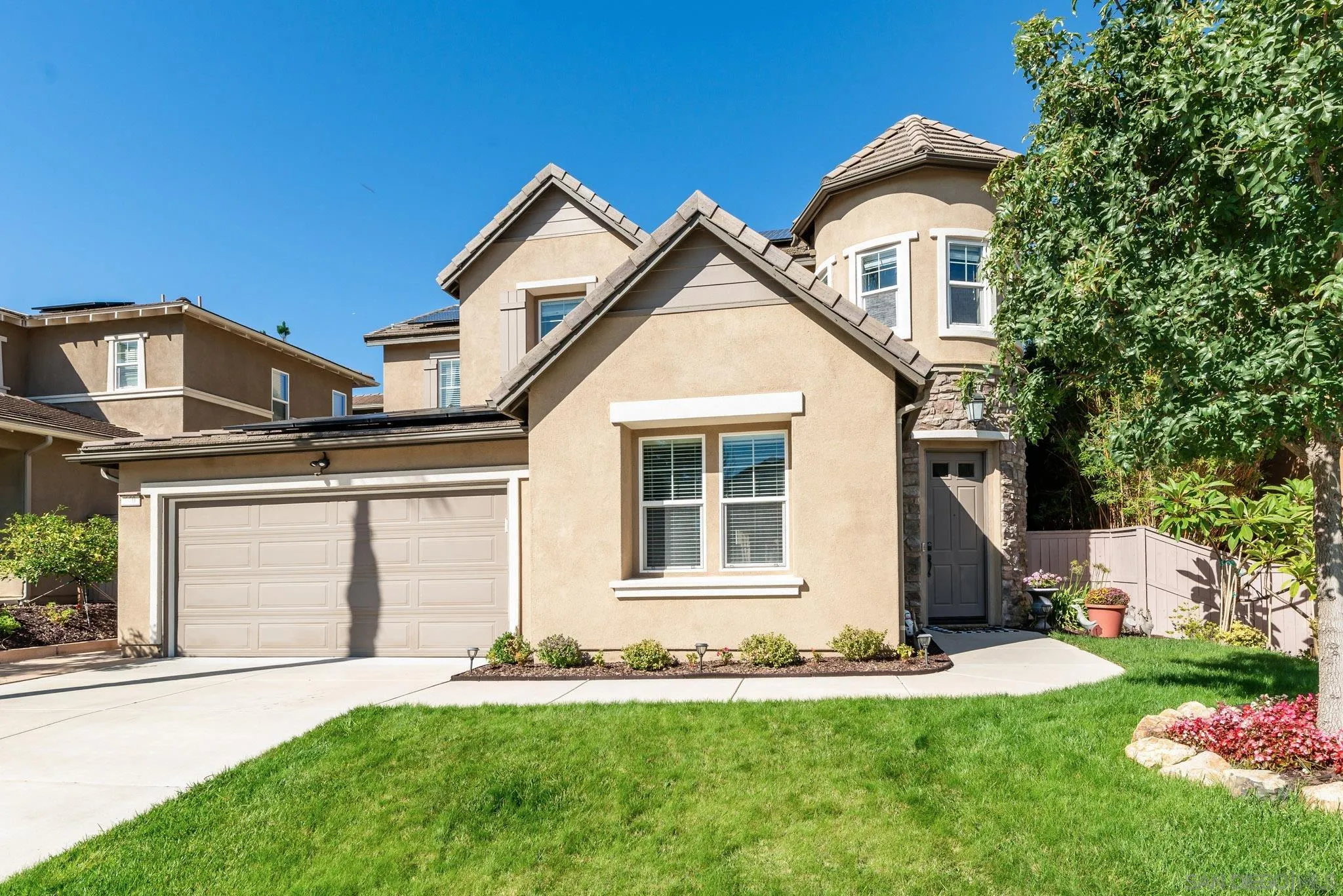 650 Liquid Amber Way San Marcos, CA 92078 - Photo 44 of 48 a front view of a house with a yard and garage
