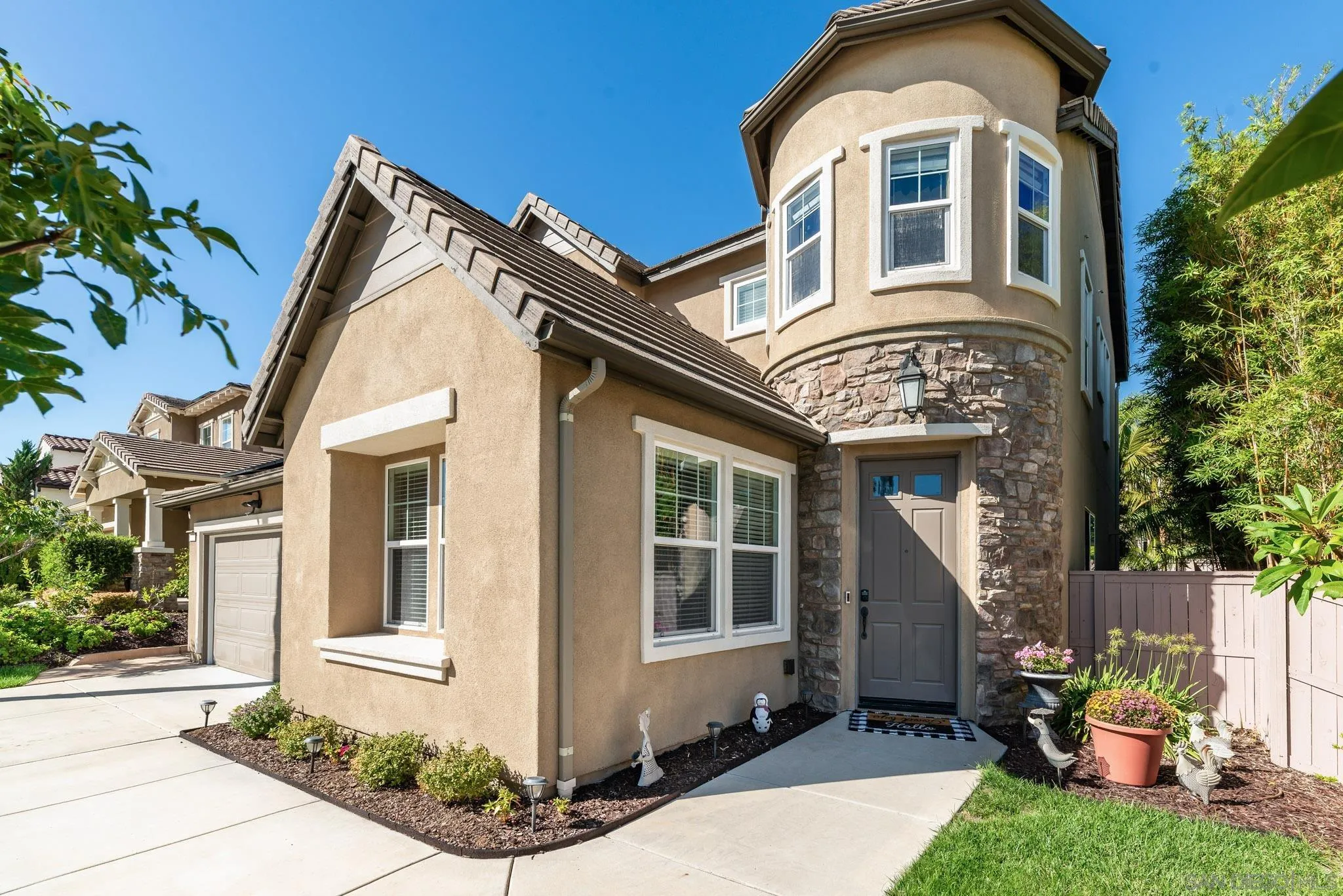 650 Liquid Amber Way San Marcos, CA 92078 - Photo 7 of 48 a front view of a house with garden