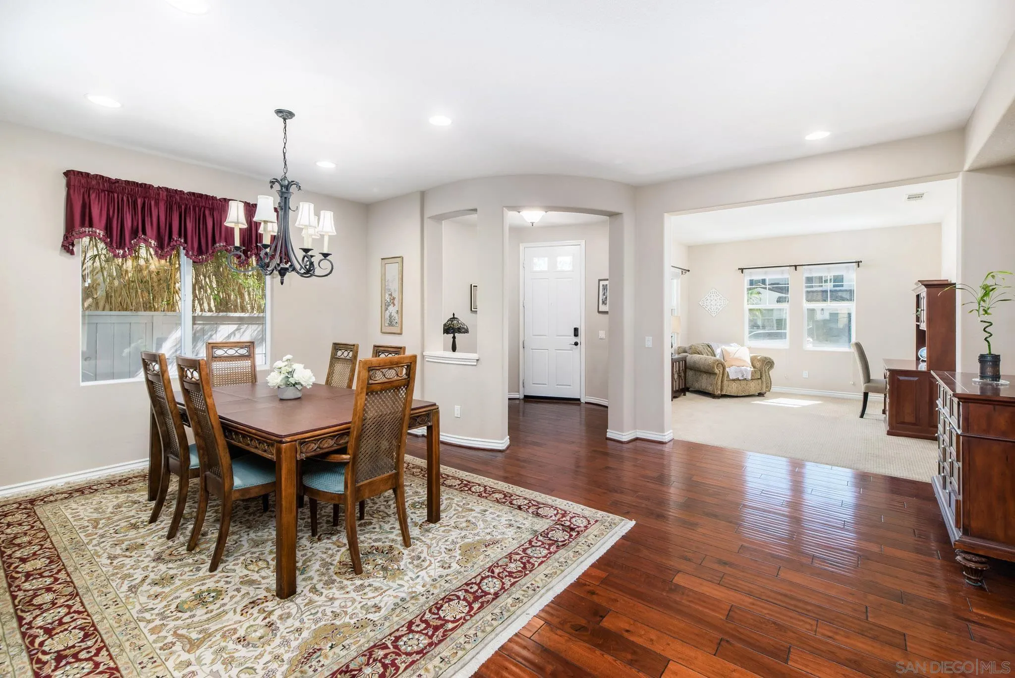 650 Liquid Amber Way San Marcos, CA 92078 - Photo 8 of 48 a view of a dining room with furniture a rug and wooden floor