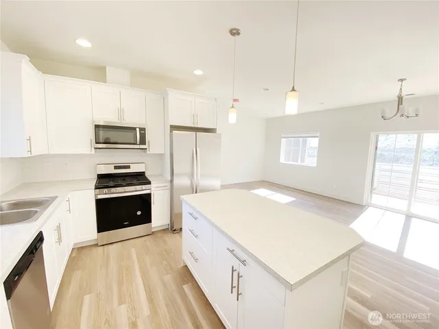 a kitchen with a stove a sink and a refrigerator