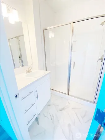 a bathroom with a sink vanity and a mirror