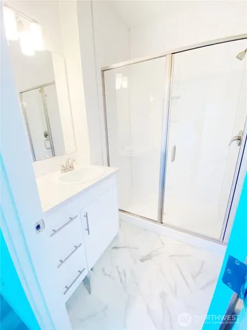a bathroom with a sink vanity and a mirror