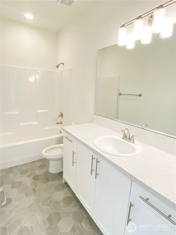 a bathroom with a sink a toilet and bathtub