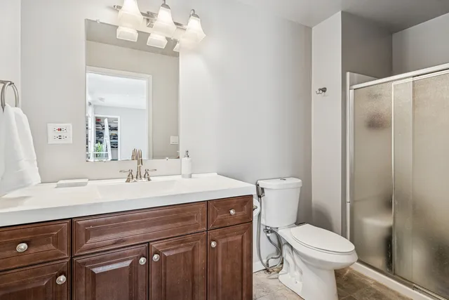 a bathroom with a sink a toilet a mirror and shower curtain