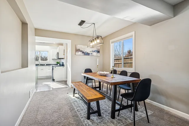 a dining room with furniture and window