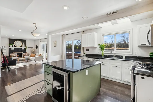 a kitchen with granite countertop a sink stove and cabinets