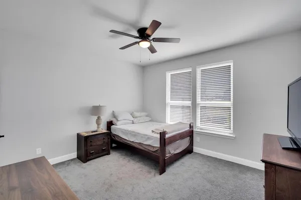 a spacious bedroom with a bed and a window