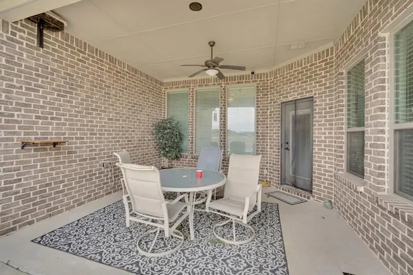 a view of a dining room with furniture and window