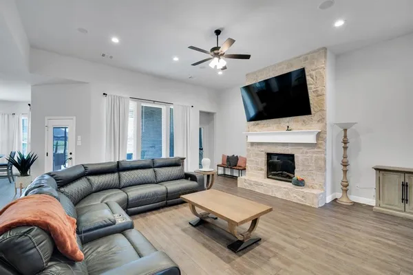 a living room with furniture a fireplace and a flat screen tv