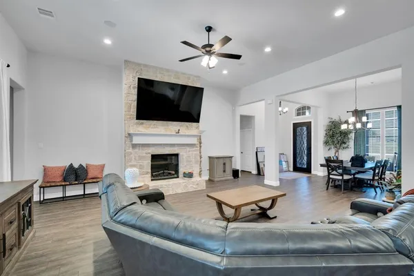 a living room with fireplace furniture and a flat screen tv