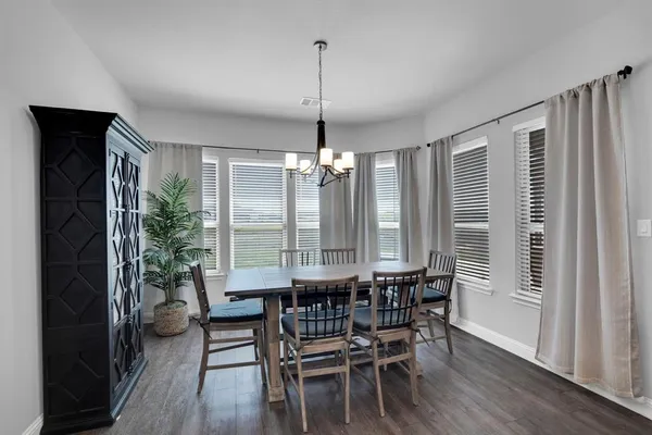 a dining room with furniture window entryway and wooden floor