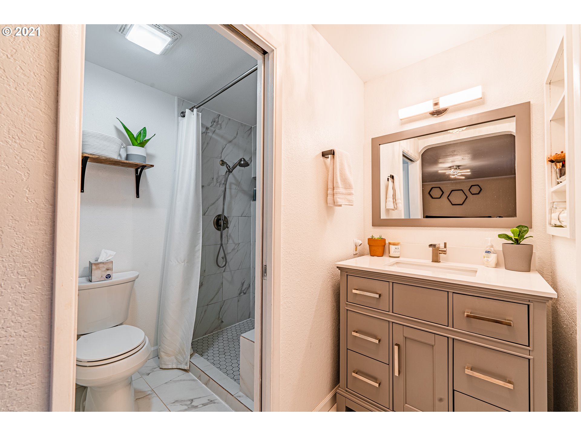 5649 E Street Springfield, OR 97478 - Photo 12 of 19 a bathroom with a toilet a sink and mirror