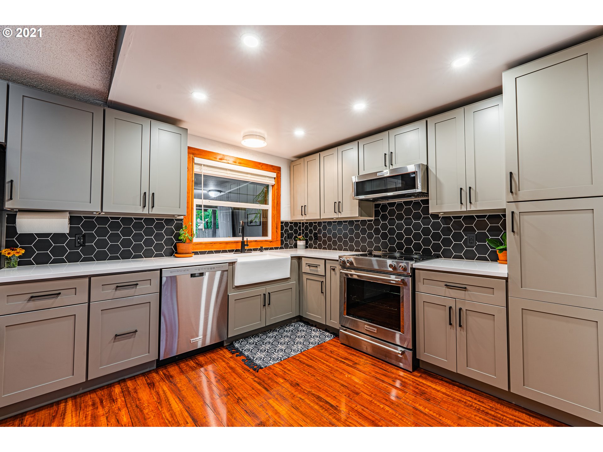 5649 E Street Springfield, OR 97478 - Photo 3 of 19 a kitchen with stainless steel appliances granite countertop a stove a sink and white cabinets