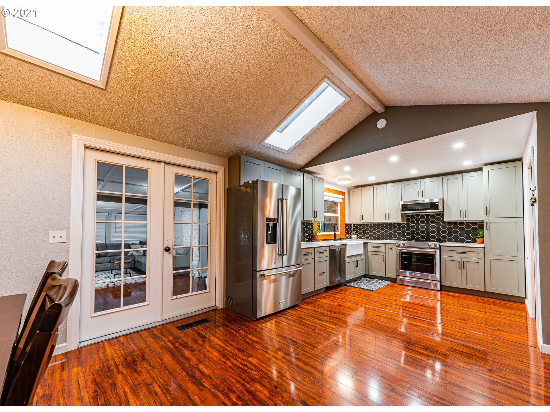 5649 E Street Springfield, OR 97478 - Photo 4 of 19 a kitchen with stainless steel appliances kitchen island granite countertop a refrigerator and a stove top oven