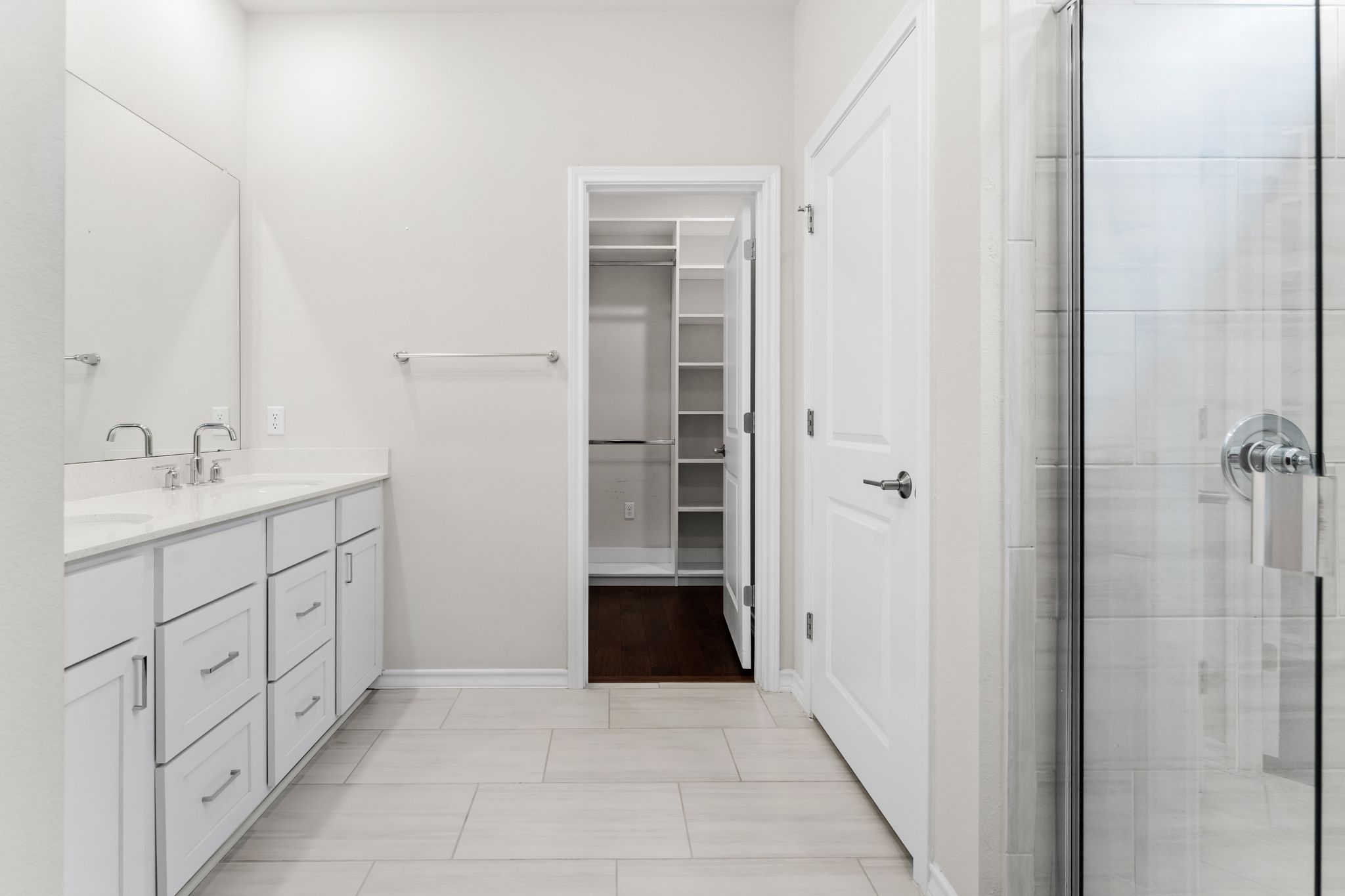 2803 Mary Elizabeth Drive Austin, TX 78728 - Photo 12 of 30 Full bathroom featuring double vanity, a spacious closet, a shower stall, and light tile patterned floors