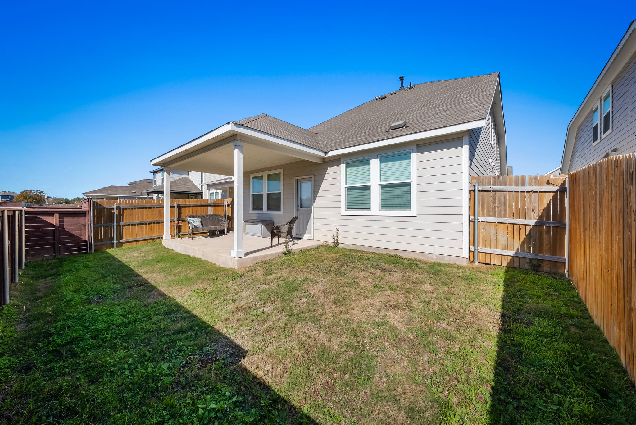2803 Mary Elizabeth Drive Austin, TX 78728 - Photo 27 of 30 Back of property featuring a patio area, a shingled roof, and a fenced backyard