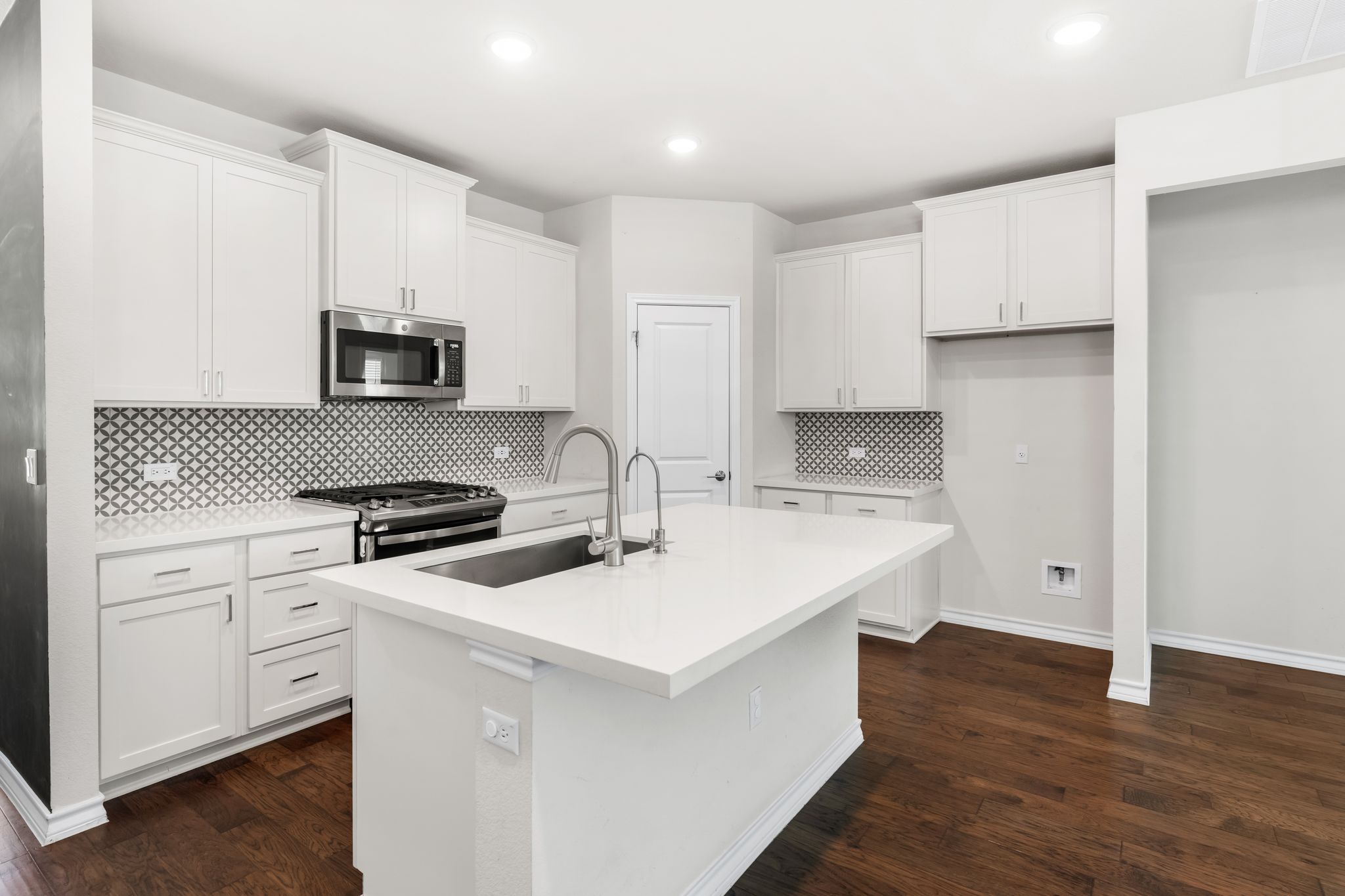 2803 Mary Elizabeth Drive Austin, TX 78728 - Photo 4 of 30 Kitchen featuring white cabinets, a kitchen island with sink, stainless steel appliances, and recessed lighting