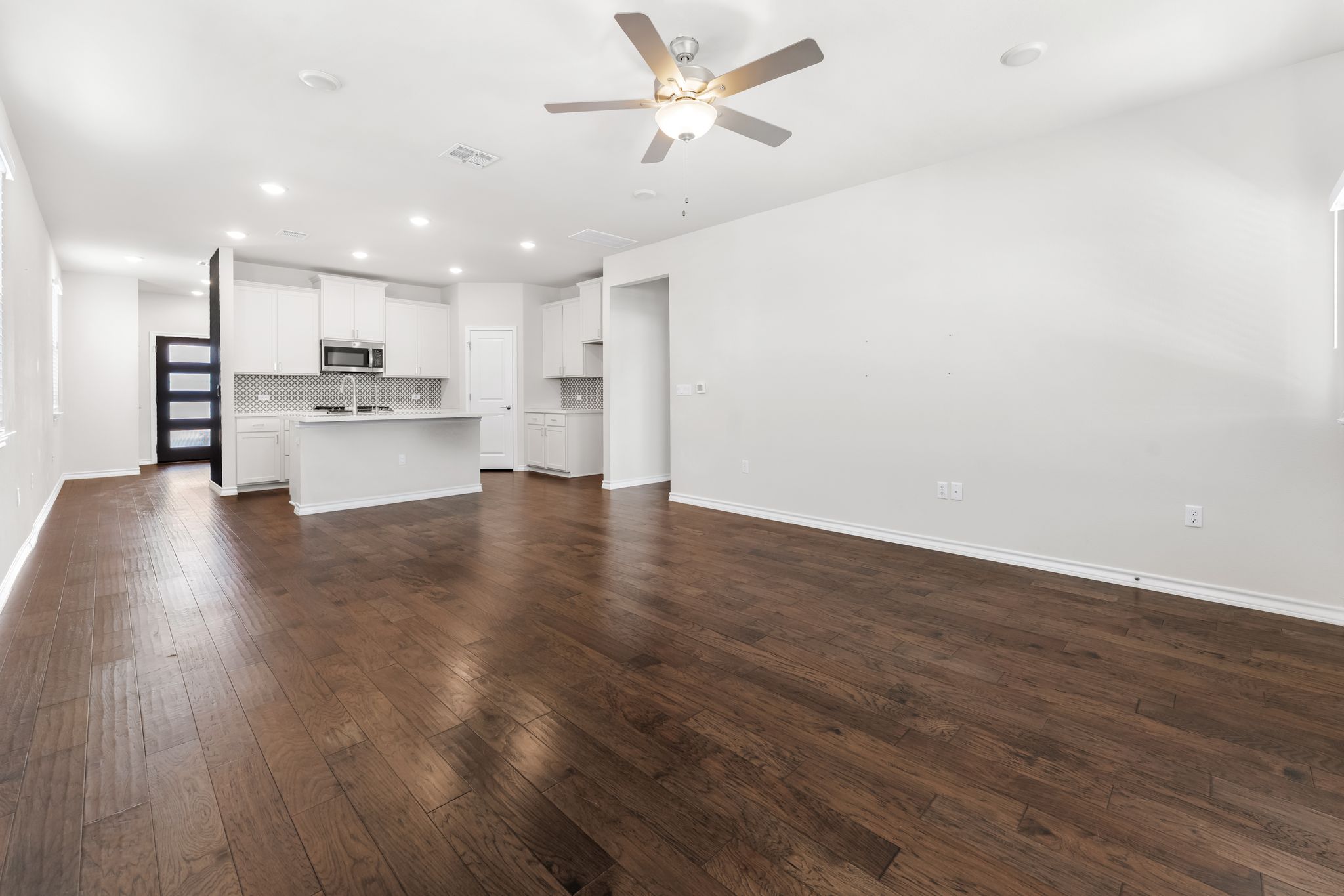 2803 Mary Elizabeth Drive Austin, TX 78728 - Photo 8 of 30 Unfurnished living room with a ceiling fan, dark wood finished floors, and recessed lighting