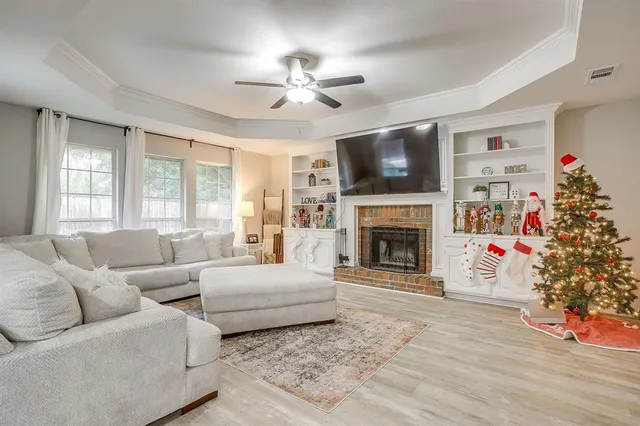 a living room with furniture a flat screen tv and a fireplace