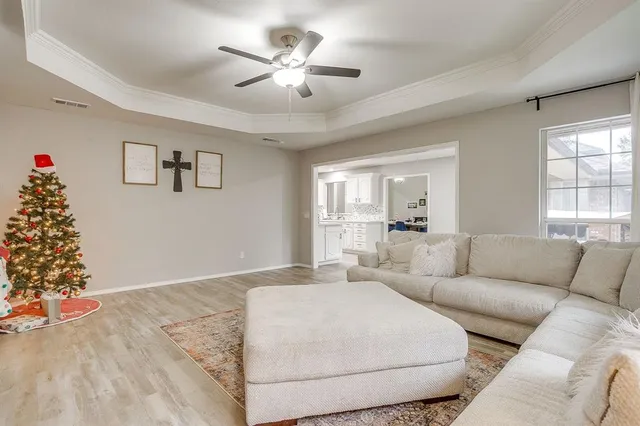 a living room with furniture and flowers